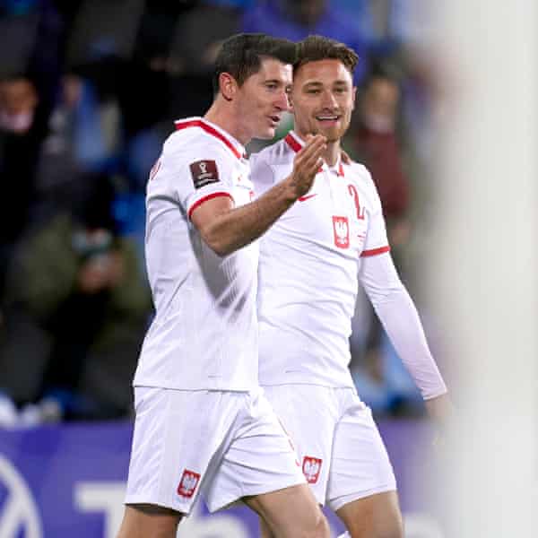Matty Cash celebrates Poland’s fourth goal with Robert Lewandowski.