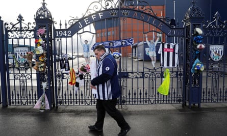 Tributes to the late Cyrille Regis are left on the Jeff Astle Gate at the Hawthorns.