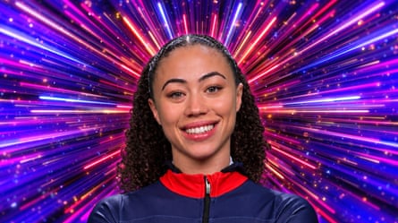 A woman with her hair in a band and a blue and red top