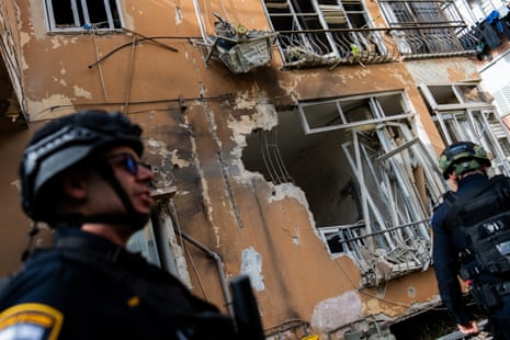 Israeli security forces inspect damage at an apartment building struck by an Iranian missile in Petah Tikva, Israel