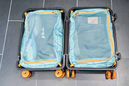 An open suitcase on tile floor