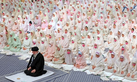Ayatollah Ali Khamenei praying with a group of Muslim teenage girls in Tehran in February.