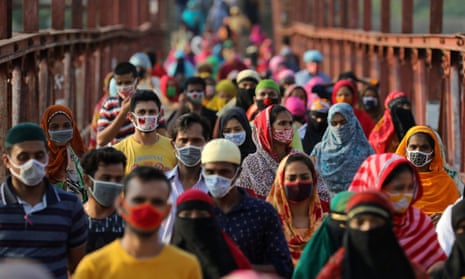 Garment workers return from a workplace in Dhaka, Bangladesh, May 4, 2020.