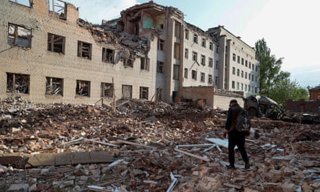 A local resident walks next to a building destroyed by a Russian military strike, as Russia’s attack on Ukraine continues, in the town of Bakhmut, in Donetsk Region, Ukraine May 29, 2022.