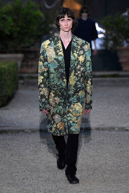 A model walks in a tapestry coat the runway at the Givenchy fashion show in June in Florence.