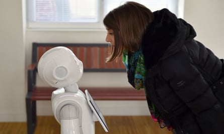 A woman interacting with a Pepper robot
