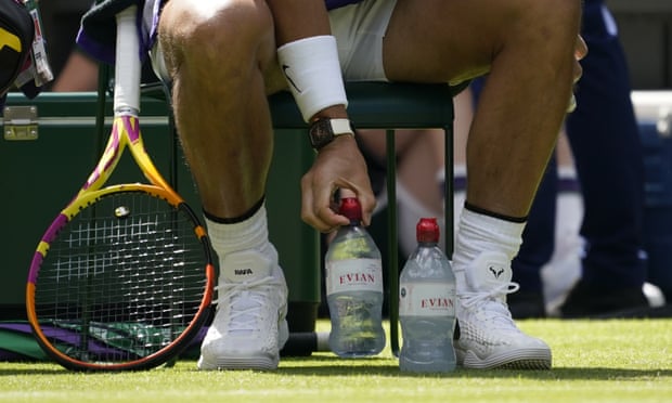 Spain's Rafael Nadal arranges his water bottles before playing Argentina's Francisco Cerundolo in a first round men's singles match on day two of the Wimbledon tennis championships on June 28, 2022