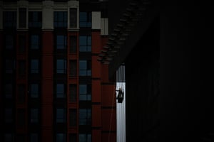 A worker uses a gondola at a construction site in Beijing