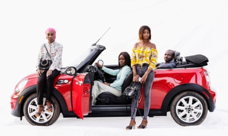 Car sales staff Aïcha, Yvonne, Fatimata and Becaye with a red convertibile Mini in Dakar, Senegal.