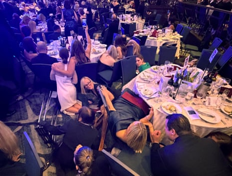 Guests take cover after U.S. President Donald Trump and first lady Melania Trump were rushed out of the White House Correspondents’ Association dinner by Secret Service agents after a loud, unidentified noise, in Washington, D.C.