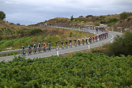 Ben O’Connor of Australia and Team Decathlon AG2R La Mondiale in the Red leader jersey as the peloton passes ‘La Rioja’ vineyards during the La Vuelta stage 18 in 2024