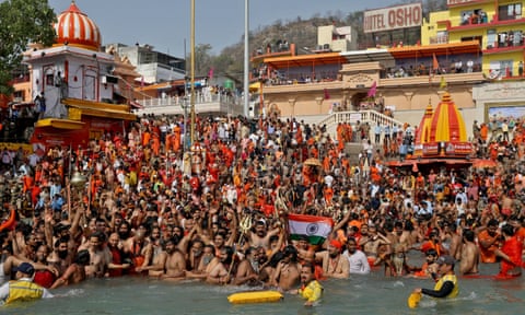 Hindu devotees take a holy dip in the Ganges during Shahi Snan at Kumbh Mela amidst the spread of the coronavirus in Haridwar, India, 14 April.