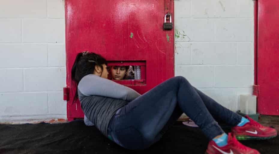 Maria, 20, talks to her cellmate Aldana, 20, who was separated due to an argument with another detainee