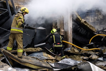 Firefighters amid rubble in Kyiv.