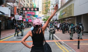 A woman confronts police during a banned protest in Hong Kong, where almost 400 demonstrators have been arrested.