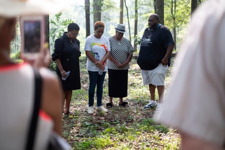 Peggy King Jorde, from left, Ayisat Idris-Hosch, Lillie Smith and the Rev Render Godfrey pay their respects to the dead of the Farmer Street cemetery.