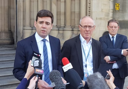 Andy Burnham and Richard Leese have microphone put to them while stood on the steps of Manchester town hall