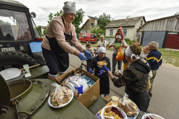 People receive food as a humanitarian aid in Novoselivka village, Chernihiv.
