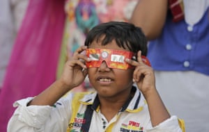 A boy looks at the sun in Lucknow, India