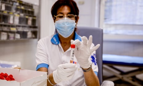 A health worker holds a coronavirus test tubes in Madrid, Spain.