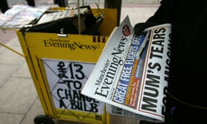 Street vendor sells Manchester Evening News.