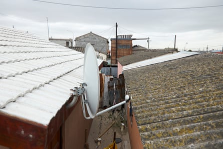 Two roofs close together, one painted white the other plain tiles.