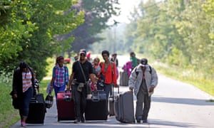 Three families from Burundi cross into Quebec at the US-Canada border from Champlain, New York on 3 August 2017.