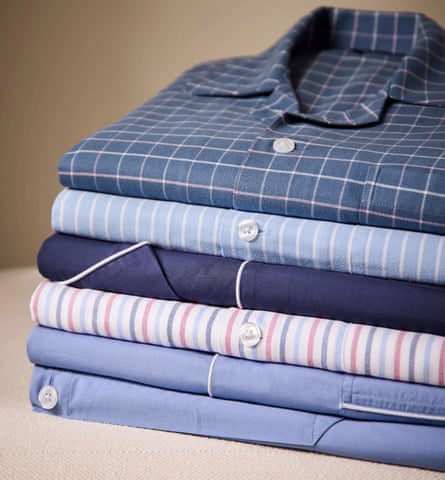 A pile of folded pyjama tops of various colours