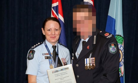 Former Detective Senior Sergeant Kate Pausina collecting a certificate from a senior officer.