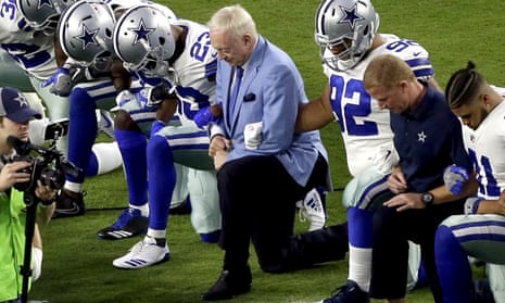 Dallas Cowboys Jerry Jones, center, initially took part in the NFL player protests but says his team must now stand for the anthem