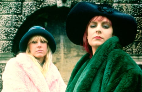 Tracey Bryn and Melissa Brooke Belland in fake-fur coats (pink and green) and wide-brimmed hats