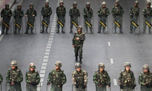 Thai soldiers guarding a bus stop area to prevent an anti-coup demonstration in Bangkok in 2014.