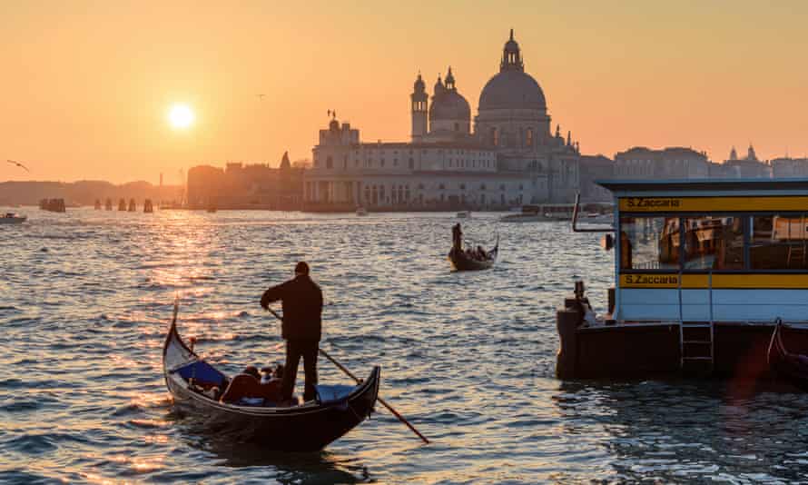 Two gondoliers on the Canale Grande in Venice