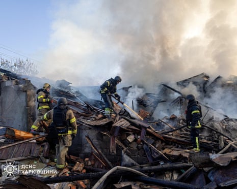 Firefighters work at the site of a private household hit during morning Russian drone strikes on Kharkiv, Ukraine.