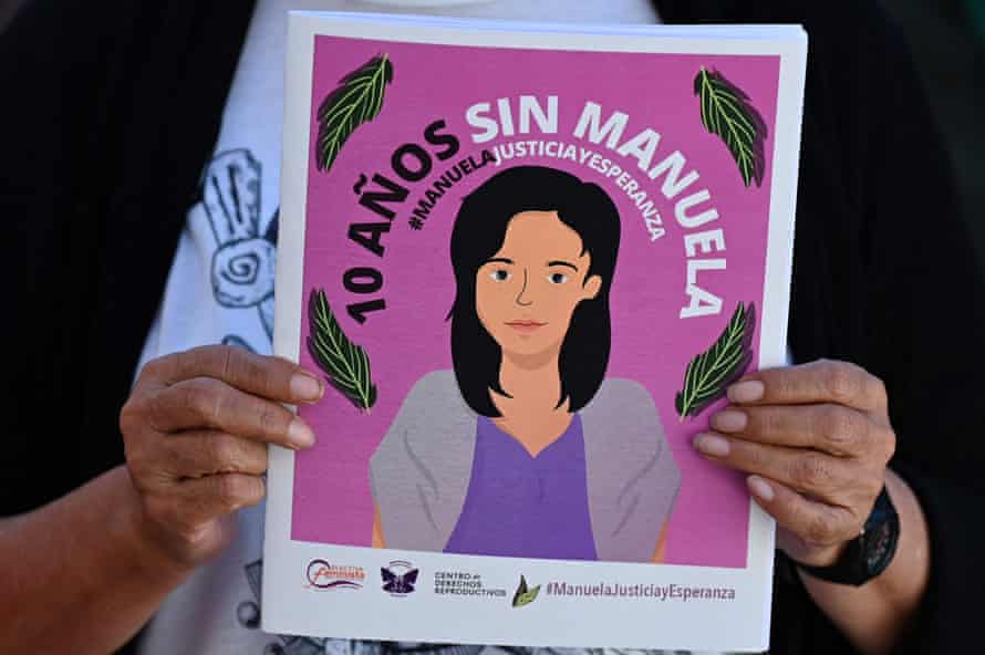A woman holds an illustration of Manuela