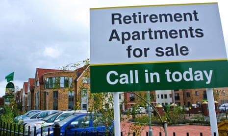 A sign outside a housing development that says 'retirement apartments for sale'