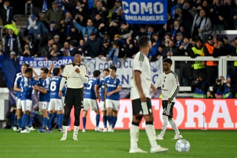Manchester United's Noussair Mazraoui bows his head as Como's players celebrate scoring behind him