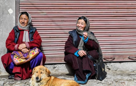 Ladakhi women are as colorful as it gets - which matches the prayer flags and adds vibrance to the harsh landscape. Here, two women sit by the streetside with their dog, in the sunshine.