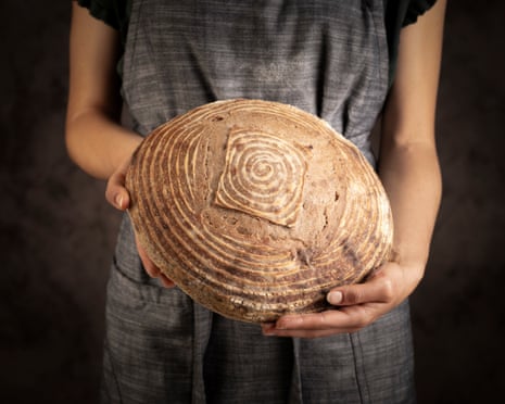 A large circular bread loaf with a spiral pattern in its crust