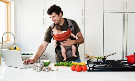 A man cooking while carrying a baby in a sling: is this macho enough for you or nah?