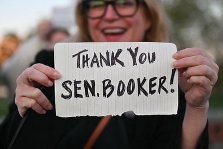 A supporter outside the US Capitol holds up a sign in support of Cory Booker after his speech.