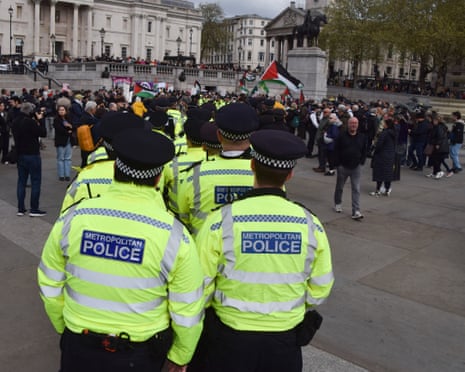 Police officers and protesters in Trafalgar Square during a demonstration in support of the activist group Palestine Action