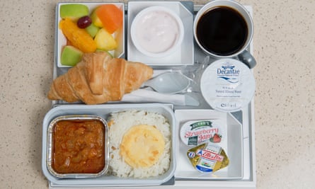 Plastic tray filled with plastic pots containing an airline meal from Malaysia Airlines.