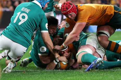 Tate McDermott gets the ball down under immense pressure.
