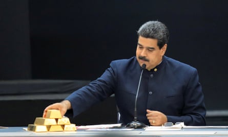 Nicolás Maduro touches a gold bar