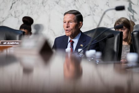 A man speaks from a chair.
