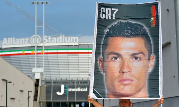 A fan holds up a banner welcoming Cristiano Ronaldo to his medical at Juventus.