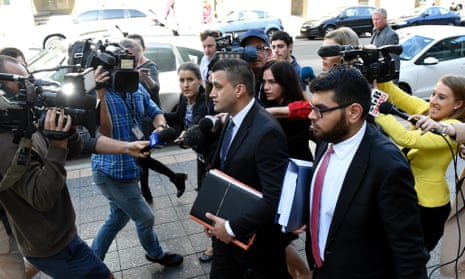 Zemarai Khatiz (centre), the lawyer representing a 16-year-old Auburn boy accused of trying to obtain a gun to use in an Anzac Day attack, leaves the Parramatta children’s court in Sydney on Tuesday. 