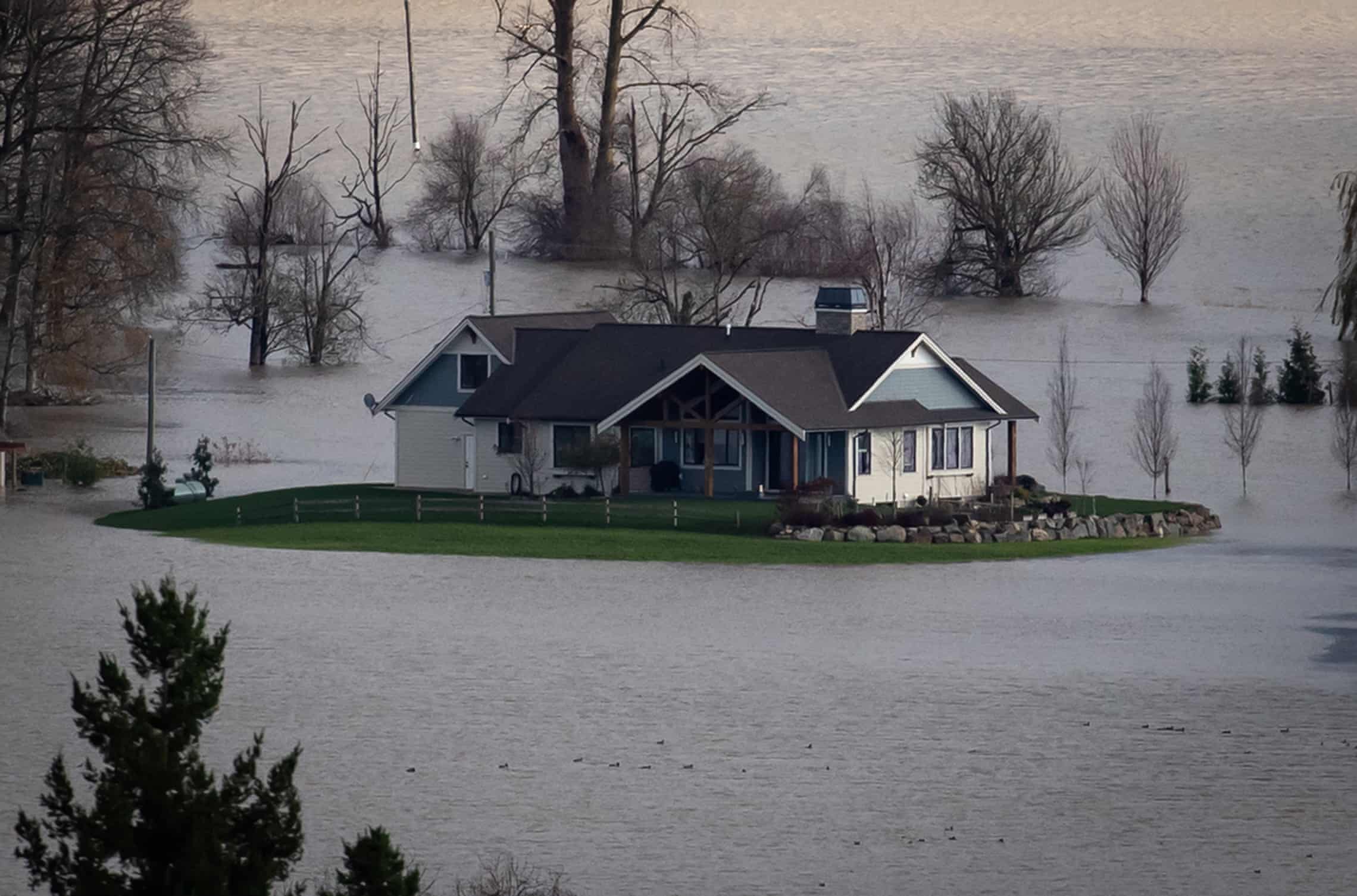 A house is seen surrounded by floodwaters on a farm in Abbotsford, British Columbia, Canada