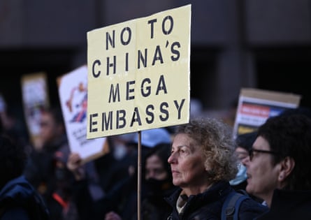 Protesters, including one holding a sign saying 'No to China's mega embassy'